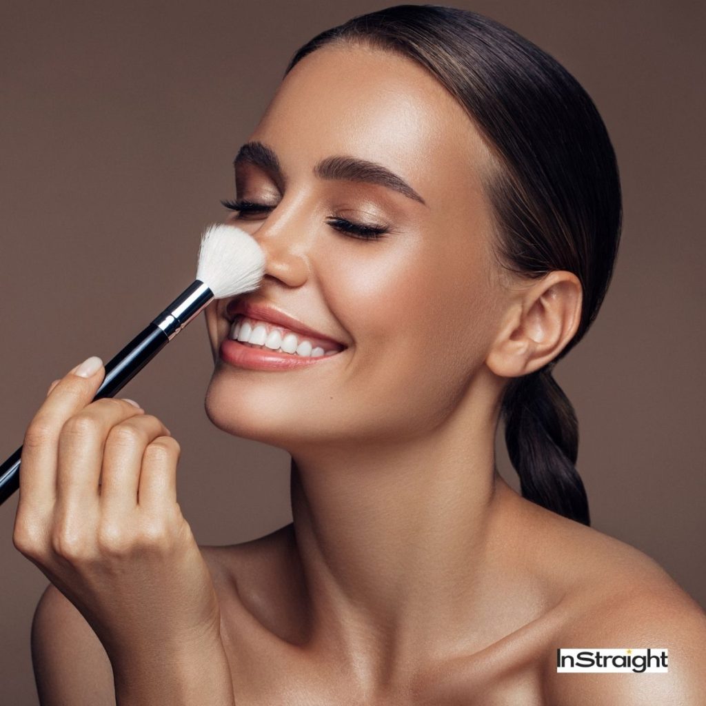 beautiful lady brushing her nose to contour